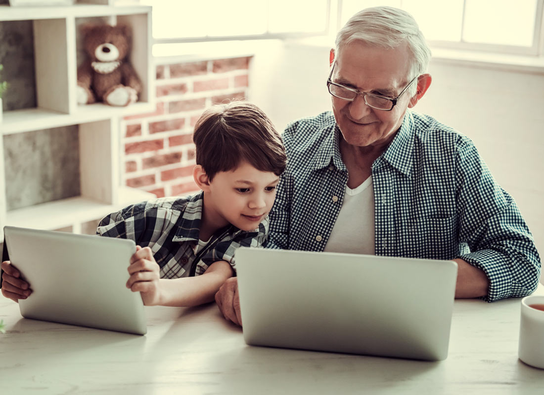 A man enjoys sharing some screen time with his grandson