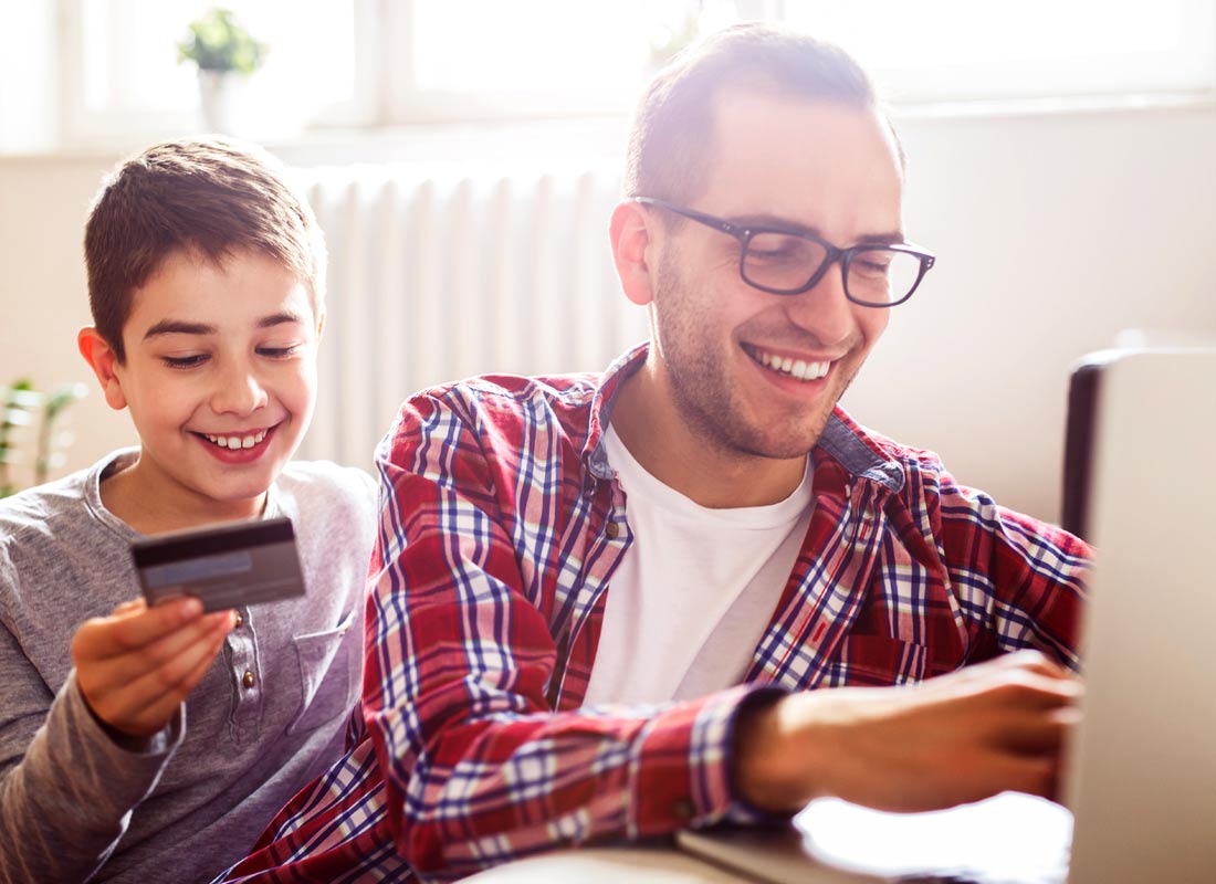 Father and son work together to buy something online by credit card