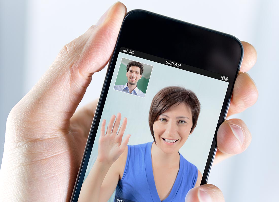 Two people catching up on Skype on a mobile phone