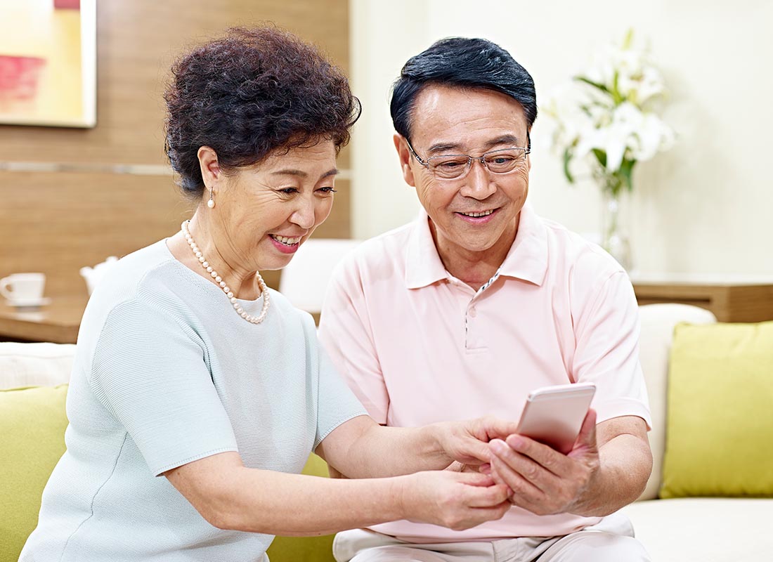 A couple saying hello to their family using a mobile device