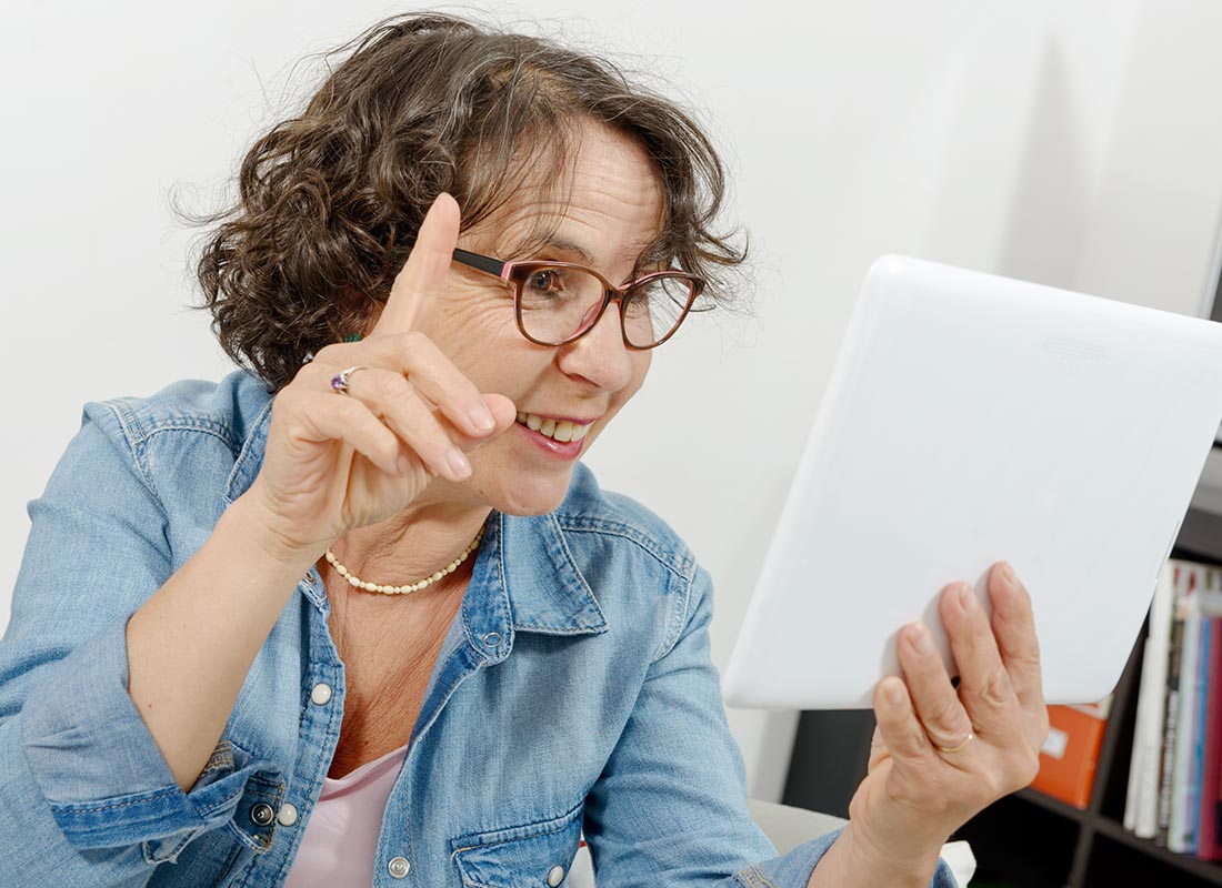 A lady joining in a video chat using her tablet device