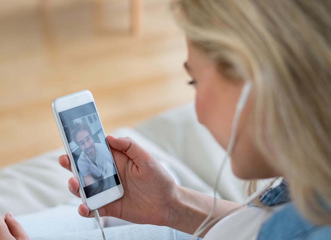 A couple using WhatsApp on their devices to catch up