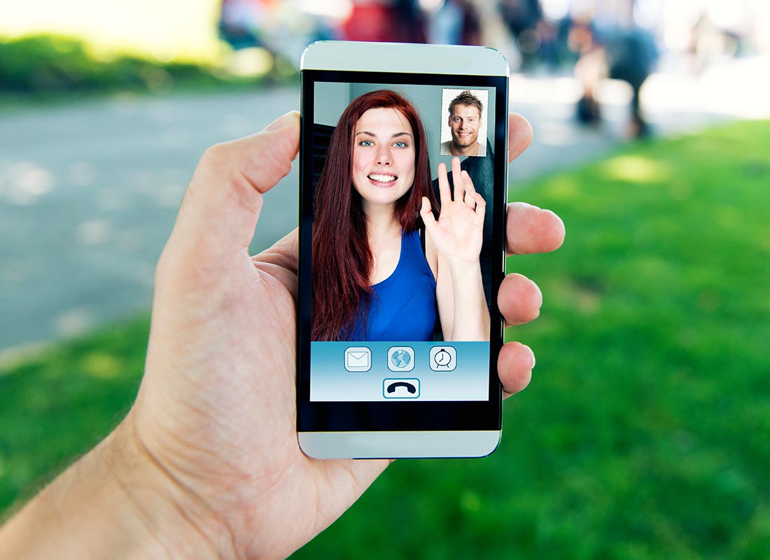 A mobile phone screen showing two people video chatting