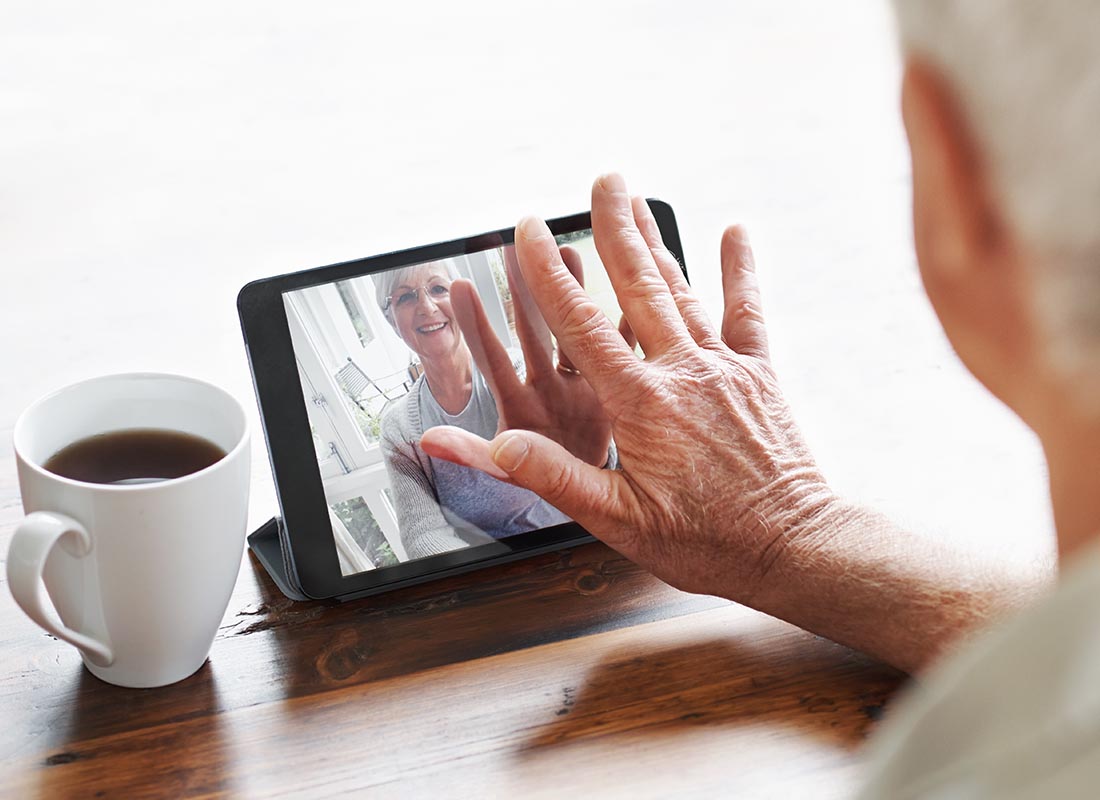 Two people saying hello over a video call