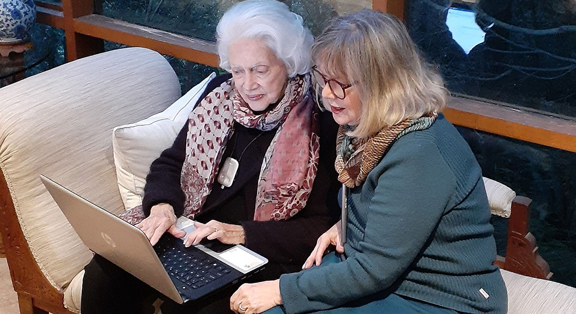 Barb helping her mother patsy as she operates a laptop computer