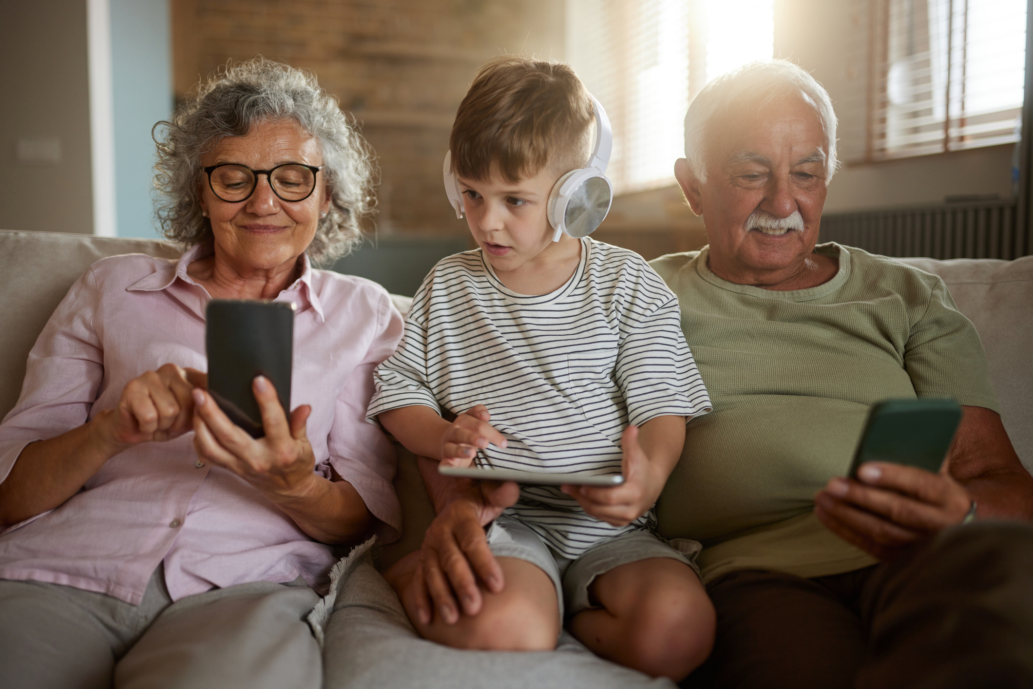 Image of grandparent playing video game with grandchild
