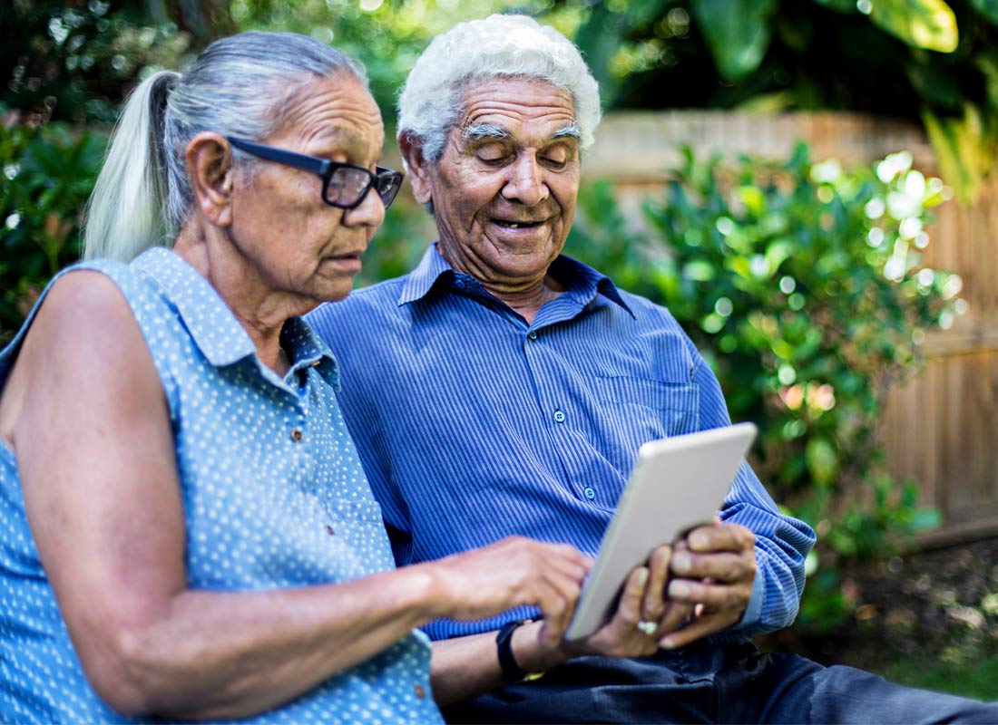 Older Indigenous couple sharing a digital tablet