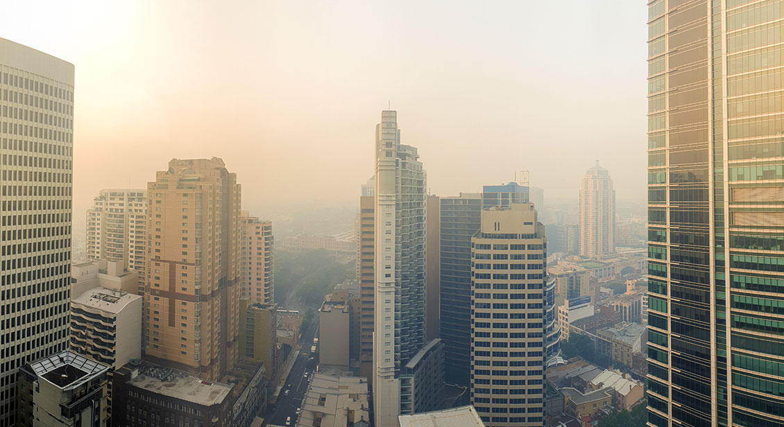Smoke pollution visible across city skyline.