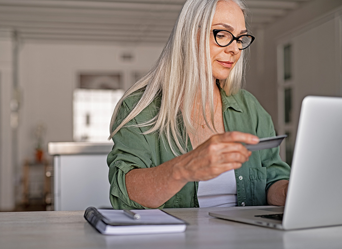 A lady checking her online bank account on her laptop computer