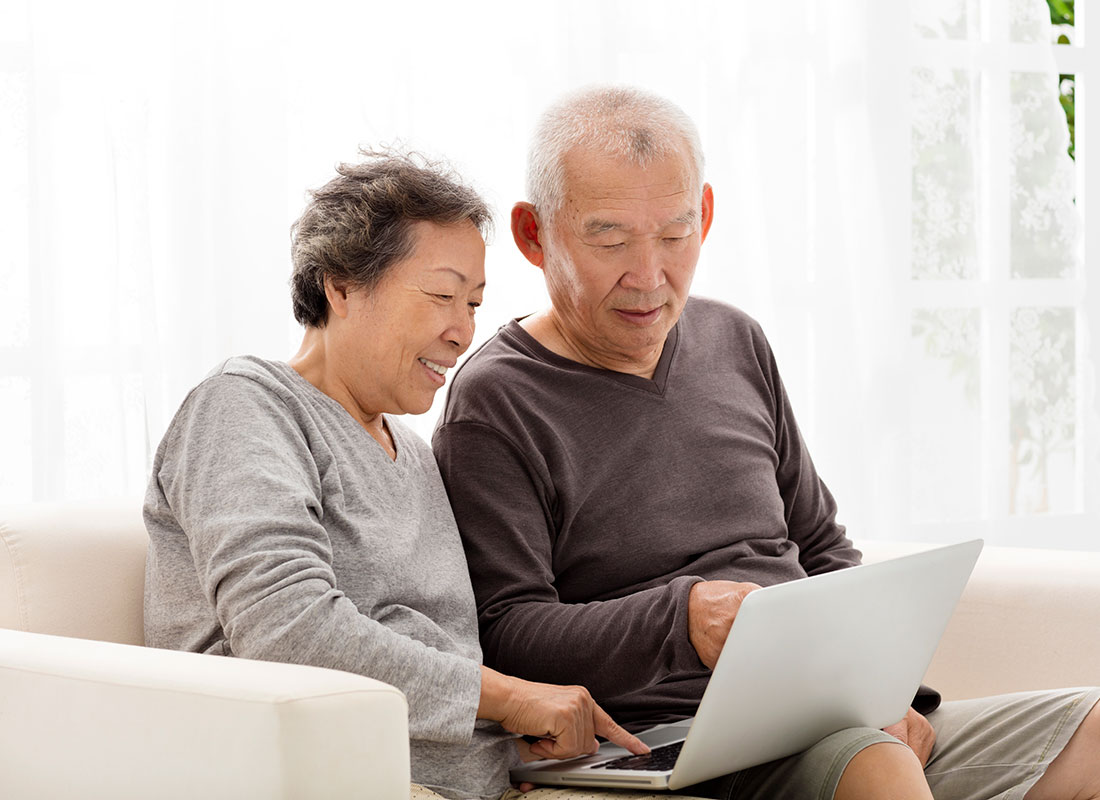 A couple doing their online banking on their laptop computer.