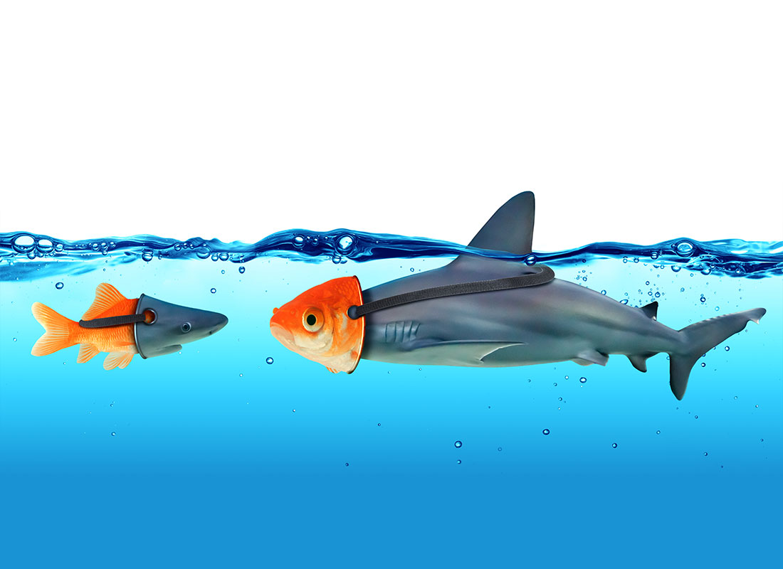 A goldfish and a shark pretending to be a shark and a goldfish by wearing masks.