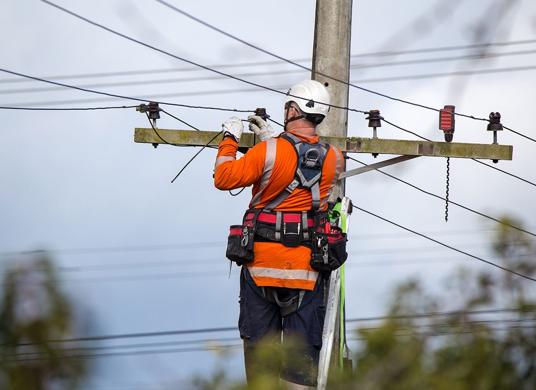 An electricity worker repairing power lines.
