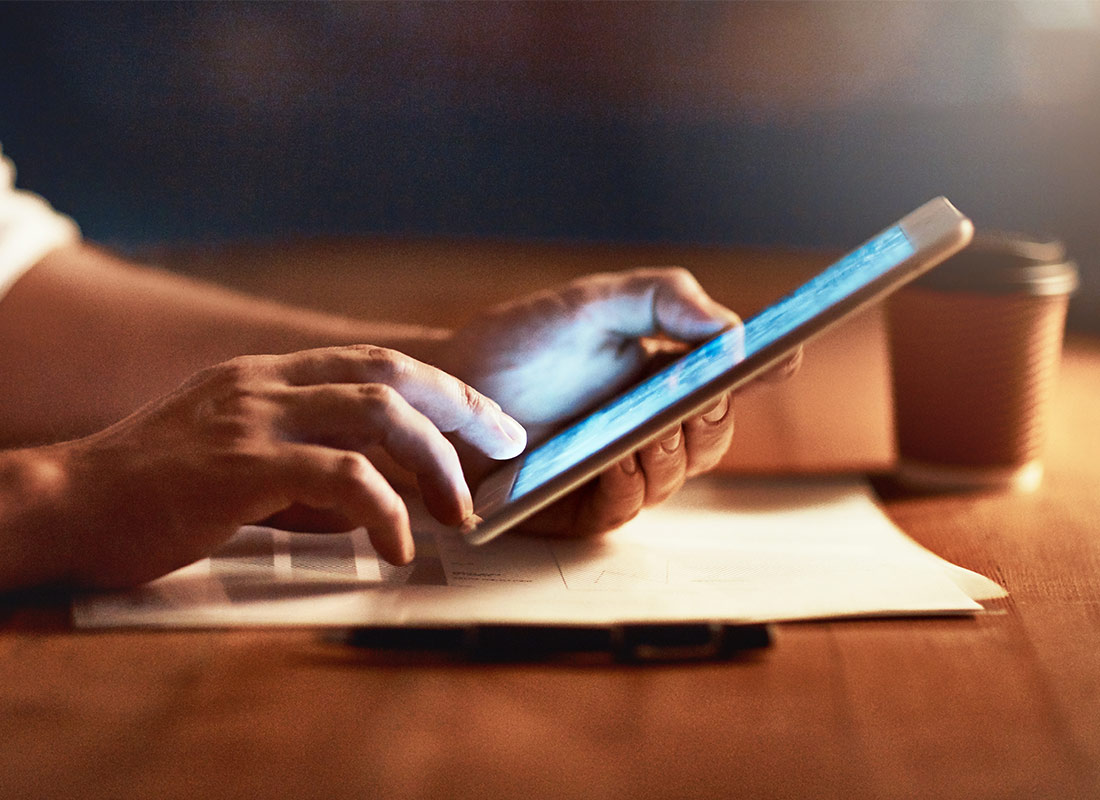 A relaxing moment with a tablet device and a cup of coffee
