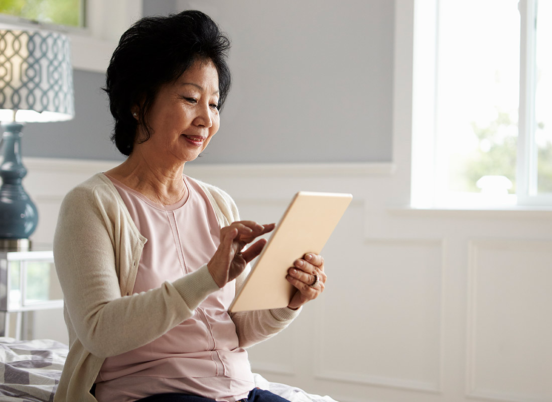 A lady catching up with her daughter using her tablet device