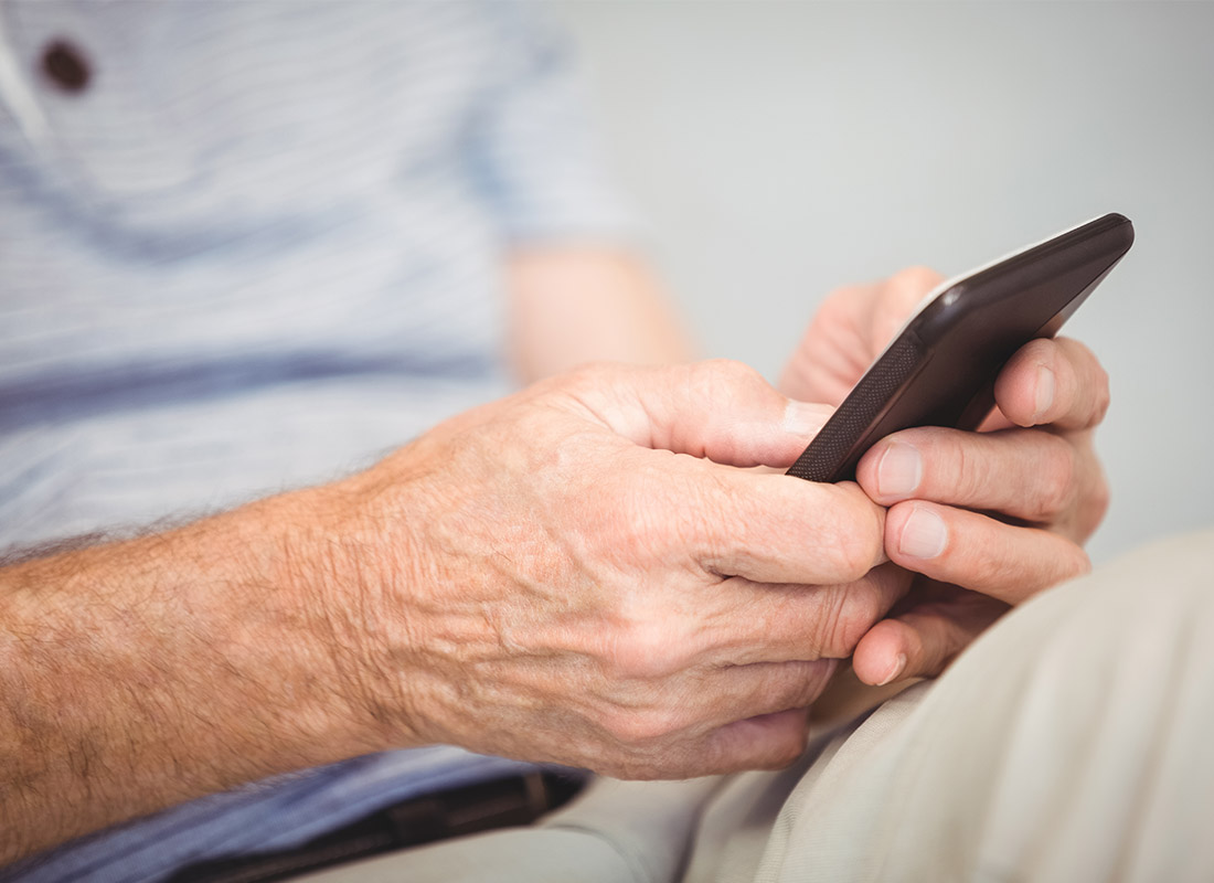 Relaxing on the couch using a mobile phone on the home Wi-Fi connection