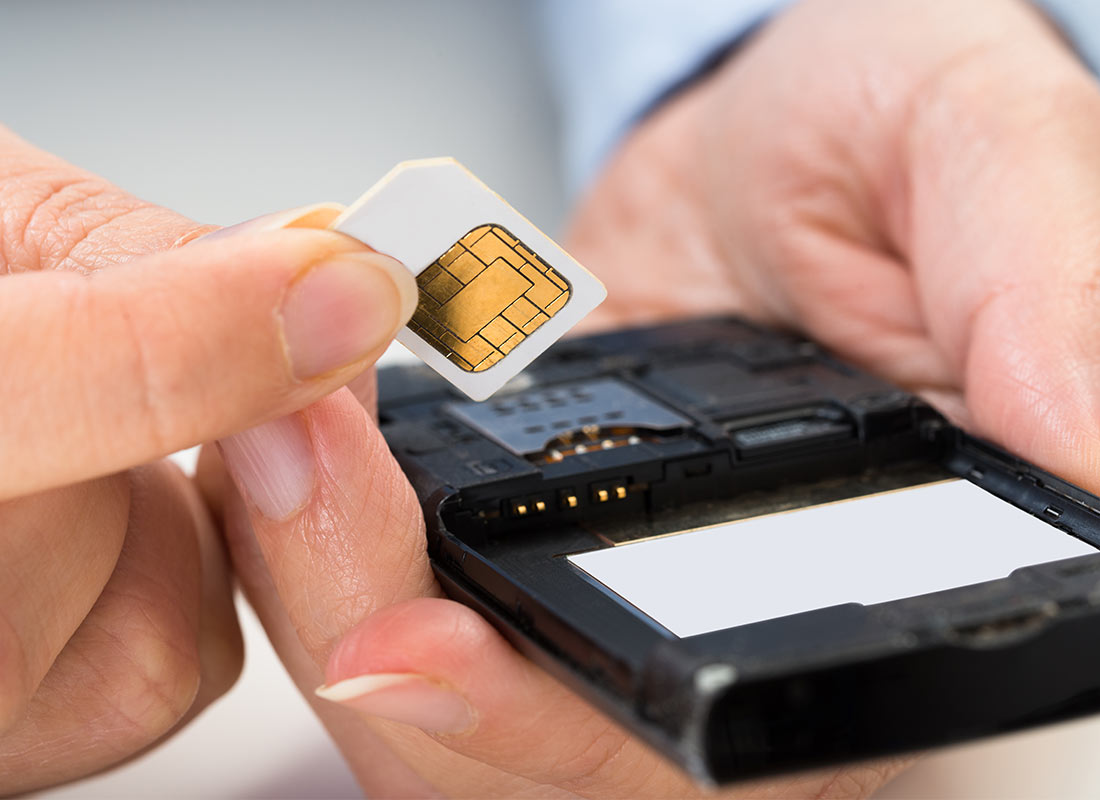 A new SIM card being inserted into a mobile phone
