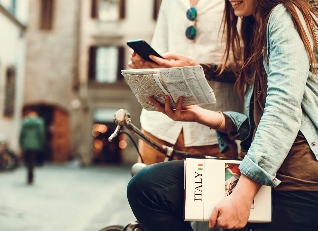 A couple checking their map against their mobile phone whilst on holiday
