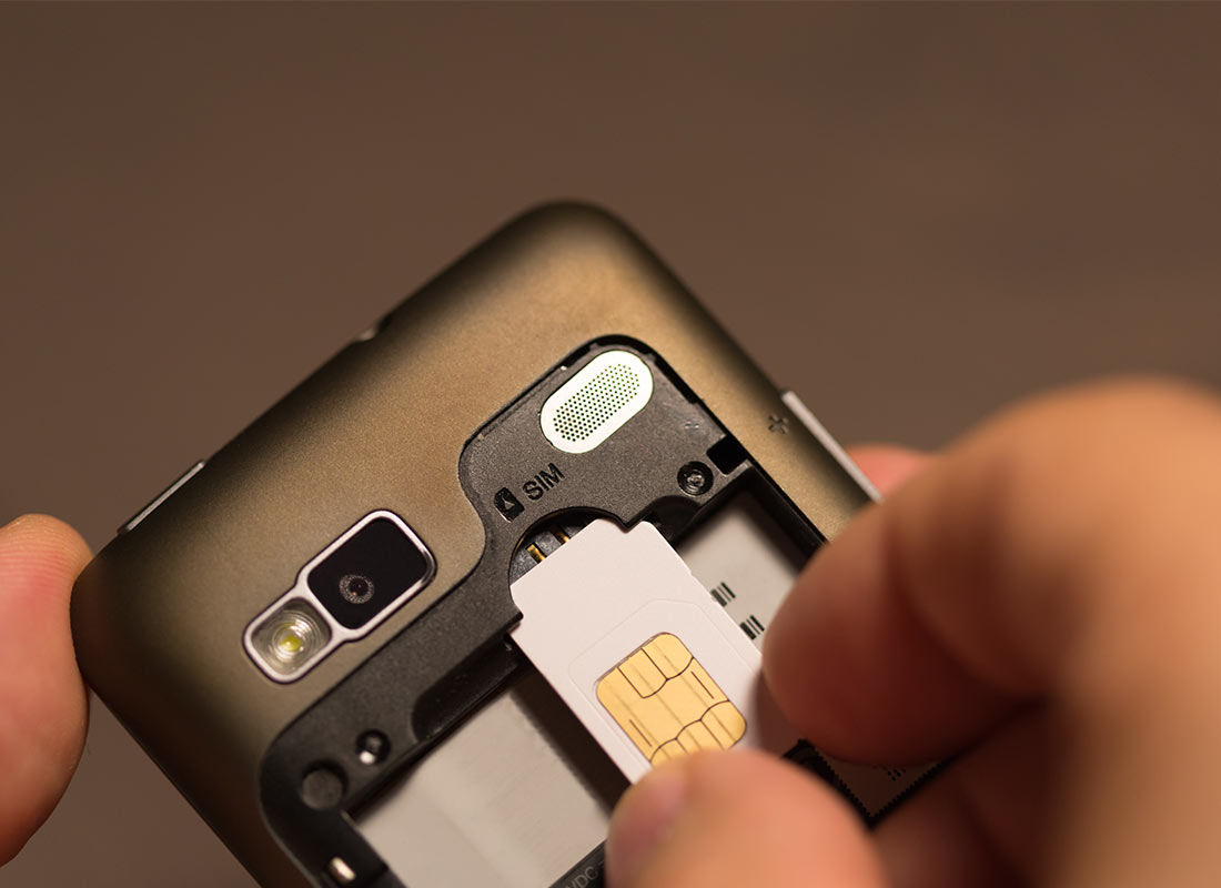 A SIM card being installed in a mobile phone