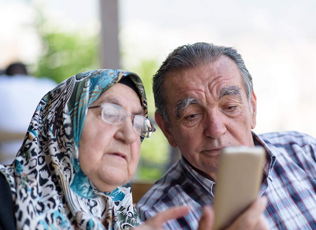 A couple checking what movies are on this afternoon at the local shopping mall