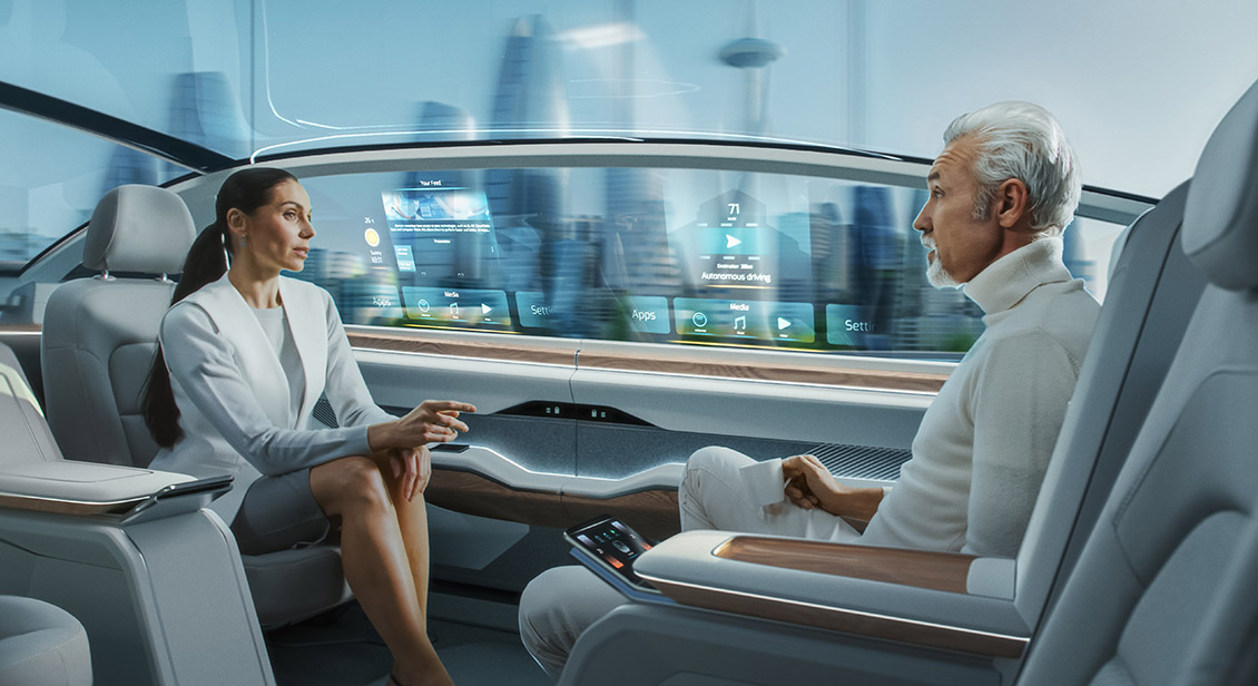 Female and male having a conversation in a driverless autonomous vehicle.
