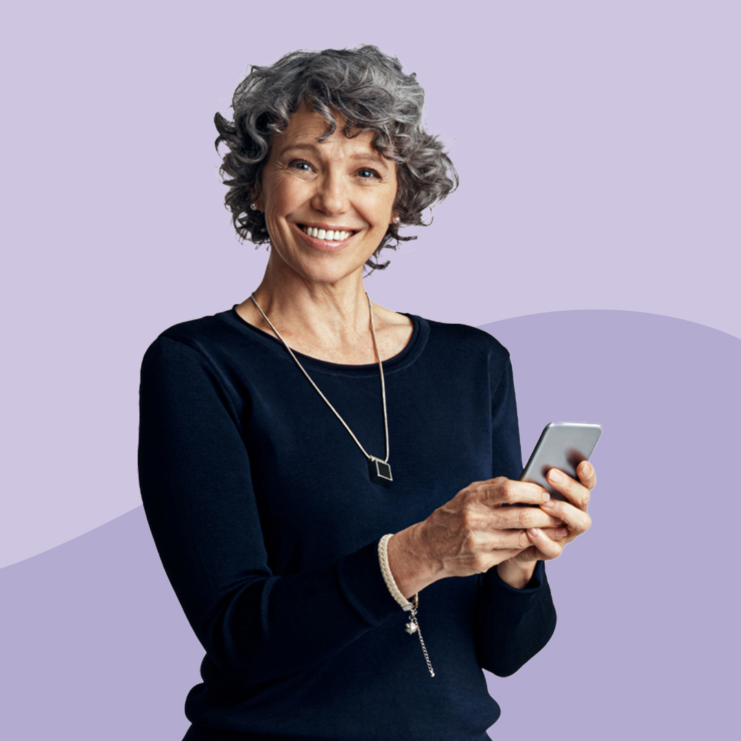 A woman using a mobile phone smiling