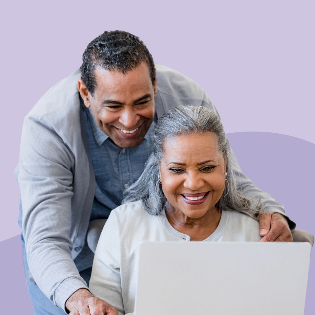 A male and female couple sharing a laptop managing their emails.