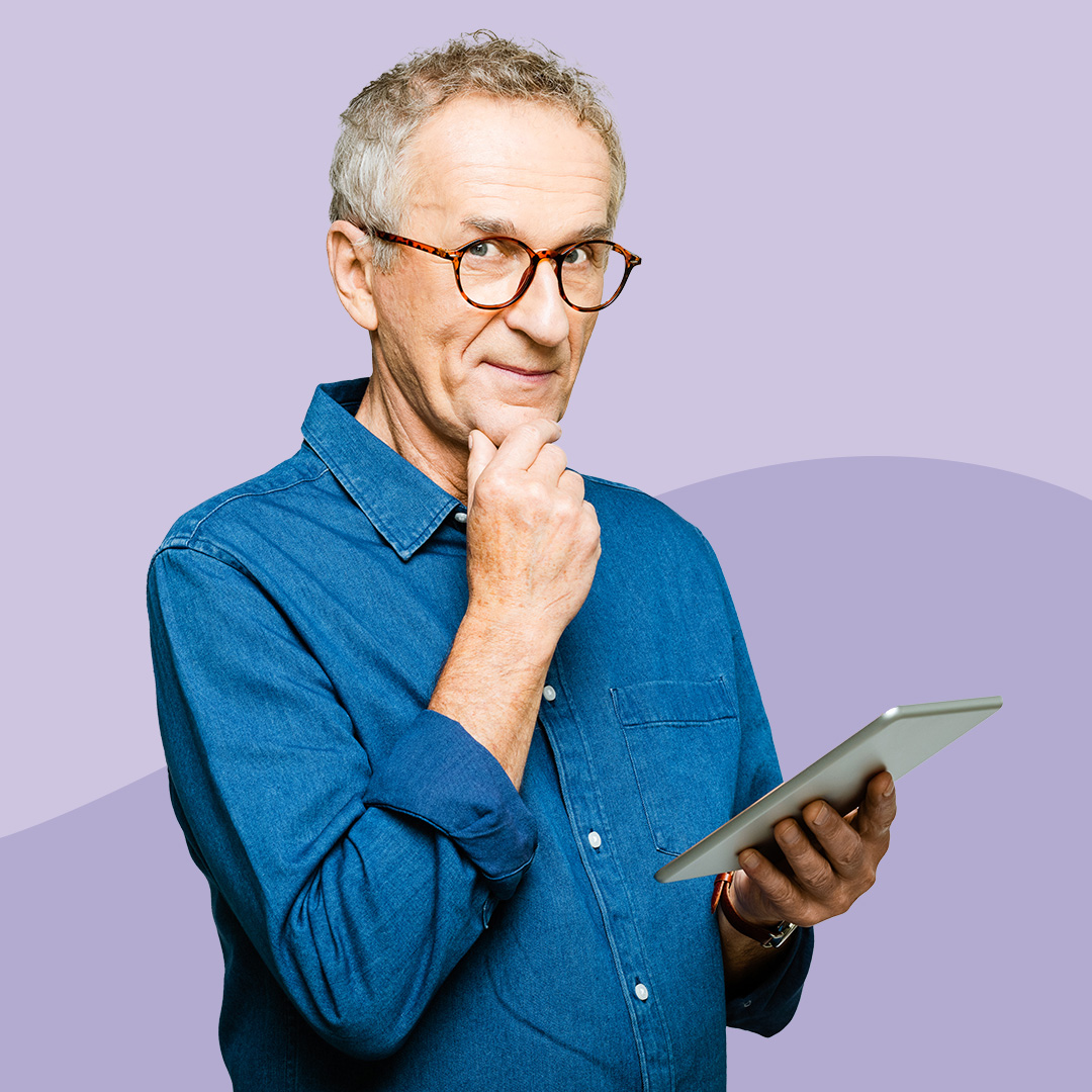 A man holding a tablet with a look of suspicion on his face