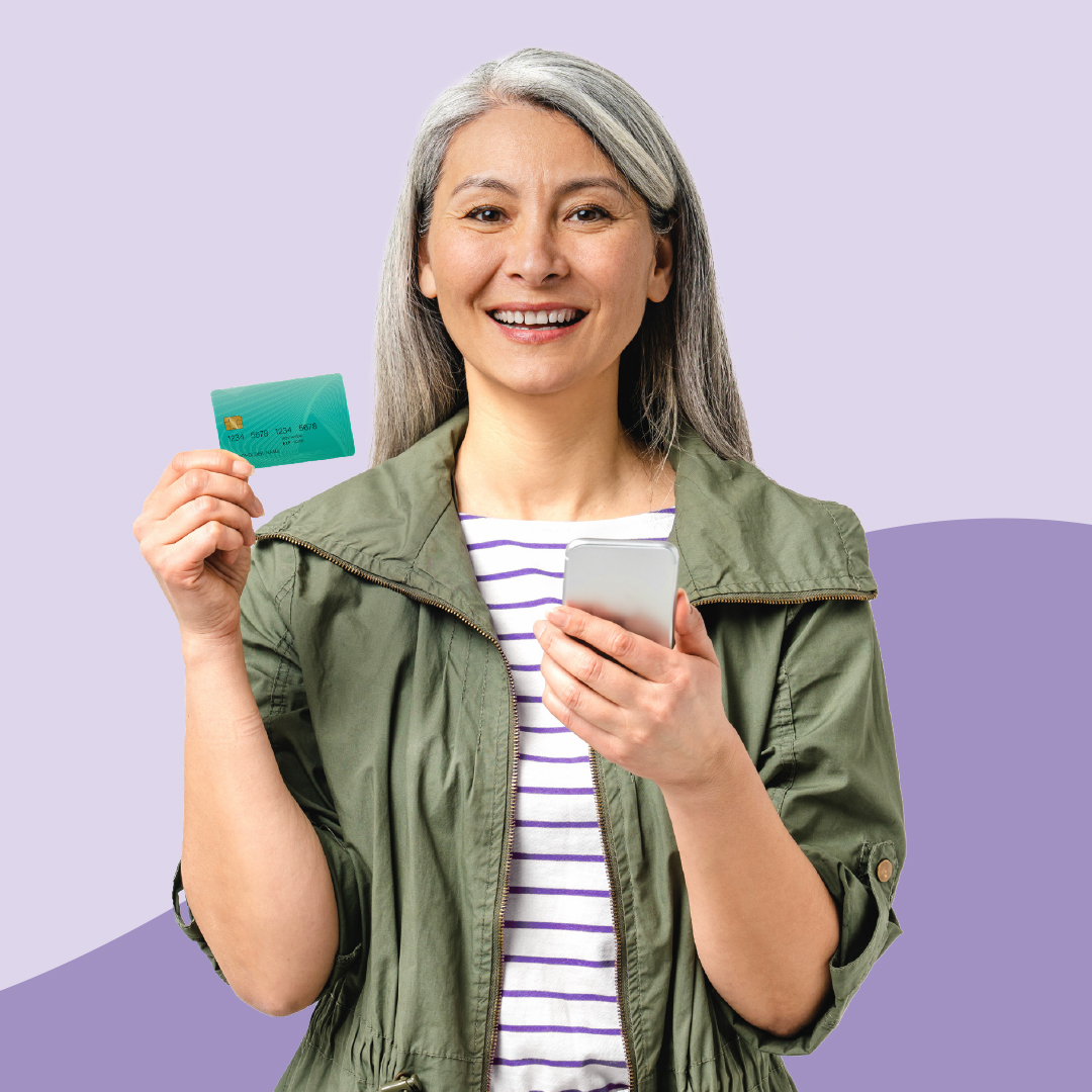 A woman using a smart phone and holding a credit card