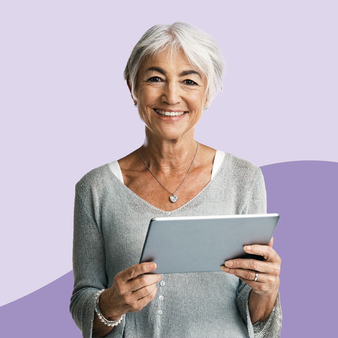 An older woman standing with tablet